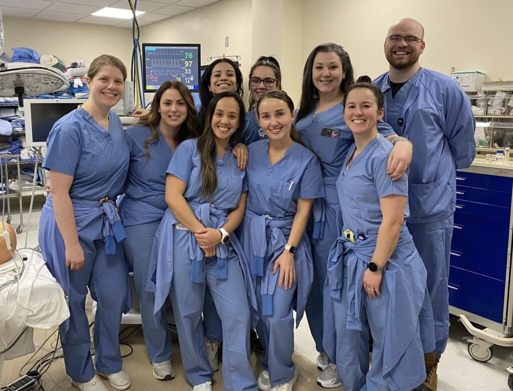 People in scrubs smiling for a picture
